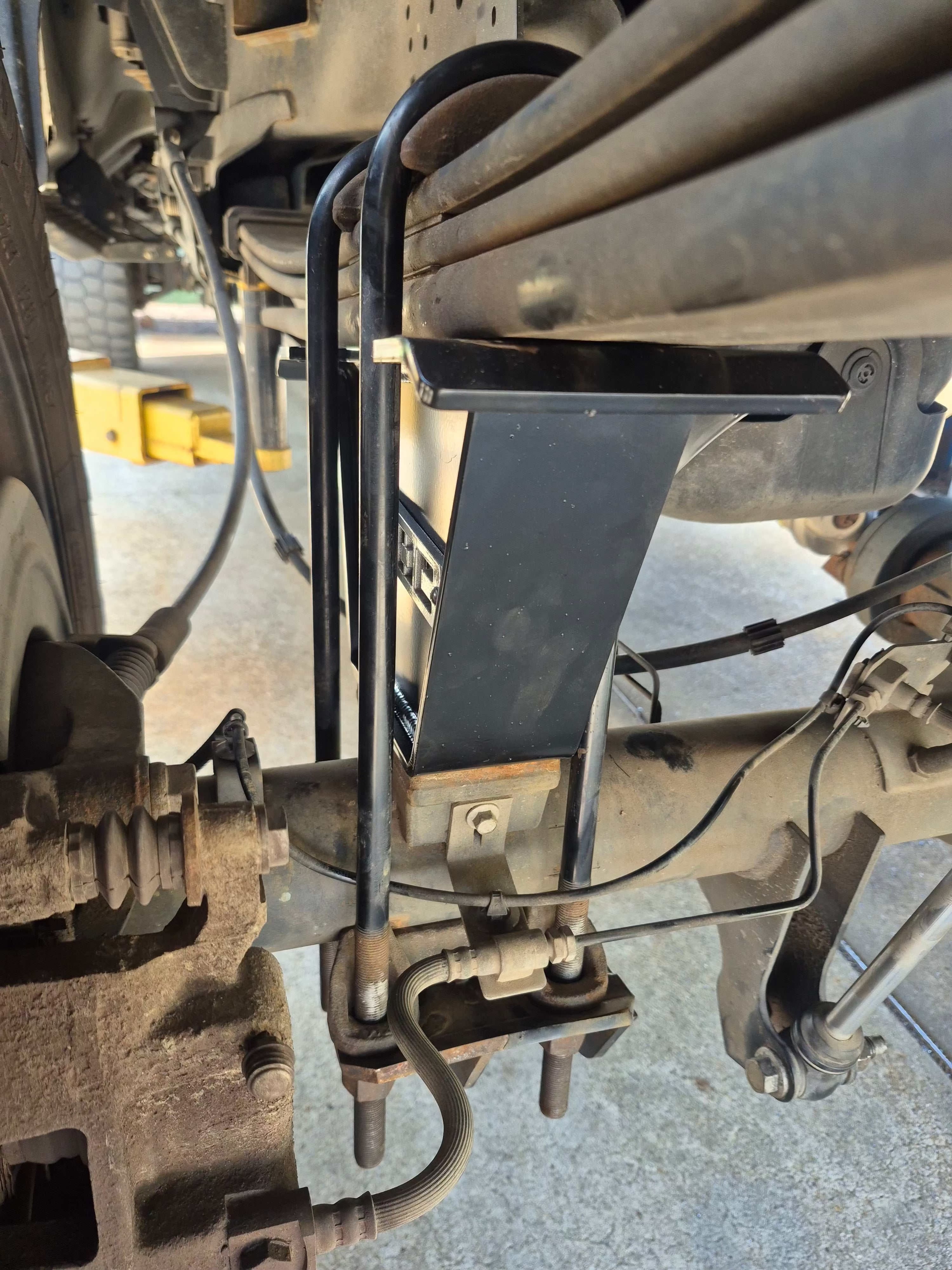Ford F-250 and F-350 Super Duty rear lift blocks with integrated bump stops and compound taper anti-wrap steel design